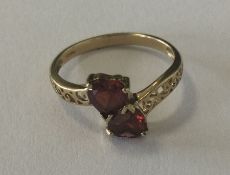 A nine carat two stone cross over ring together wi