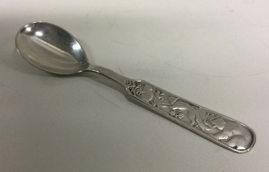 A silver christening spoon chased with foxes. Appr