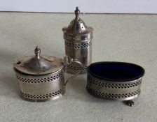 An Edwardian silver three piece cruet with pierced