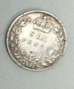 A Queen Victoria sixpence dated 1884.