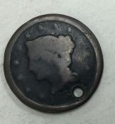 A large USA one cent (holed) dated 185(?).