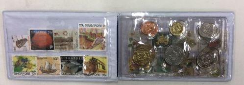 A set of 12 Singapore coins and 16 stamps.