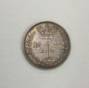 A Queen Victoria 4 pence dated 1877.