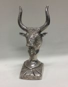 A heavy silver figure of an animal with horns. App
