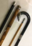 Four silver mounted walking sticks. Est. £30 - £40