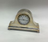 A silver mounted mantle clock with white enamelled