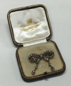 An attractive diamond brooch in the form of a bow