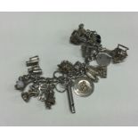 A large silver curb link charm bracelet. Approx. 8