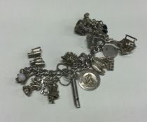 A large silver curb link charm bracelet. Approx. 8