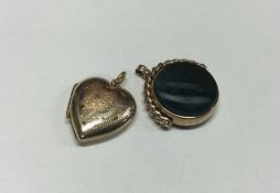 A small gold spinning fob together with a locket.