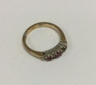 A 9 carat ruby and diamond seven stone ring. Appro