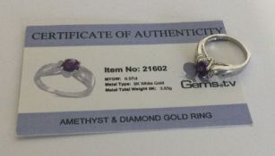 An amethyst and diamond ring set in 9 carat white