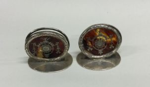 A pair of silver and tortoiseshell menu holders. L