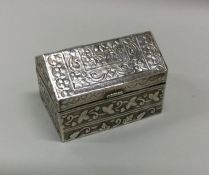 A chased silver box in the form of a barn. Marked
