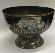 A heavy silver half fluted rose bowl on sweeping p