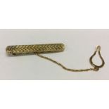 A good quality 18 carat gold tie clip of textured