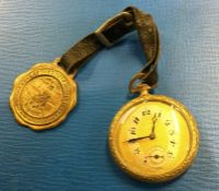 A gold plated slim pocket watch together with a me