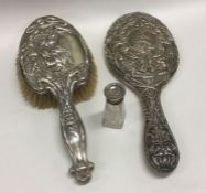 A silver mounted hairbrush together with a mirror