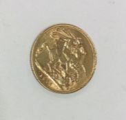 A 1911 full sovereign. Est. £300 - £350.