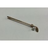A small gold brooch in the form of a golf club. Ap
