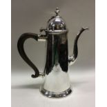 A George I silver chocolate pot with hinged lid. M