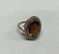 A good pearl and topaz ring in 9 carat setting. Ap