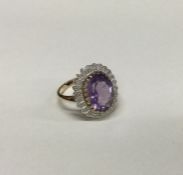 A small amethyst and diamond cluster ring in 9 car