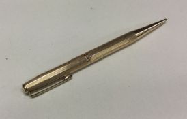 A rolled gold pencil with engine turned decoration