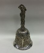 A heavy and impressive silver table figural bell.