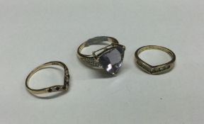 Three gold gem set rings. Approx. 8 grams. Est. £5