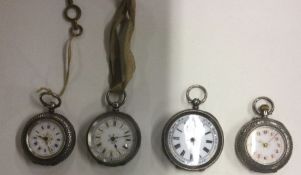 A group of four silver fob watches. Est. £25 - £35