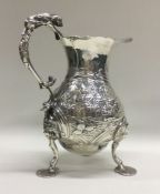 A George II chased silver chinoiserie jug decorate