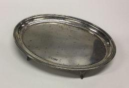 A Georgian style oval silver teapot stand with ree