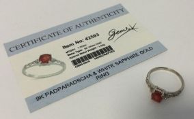 A padparadscha and white sapphire ring set in 9 ca