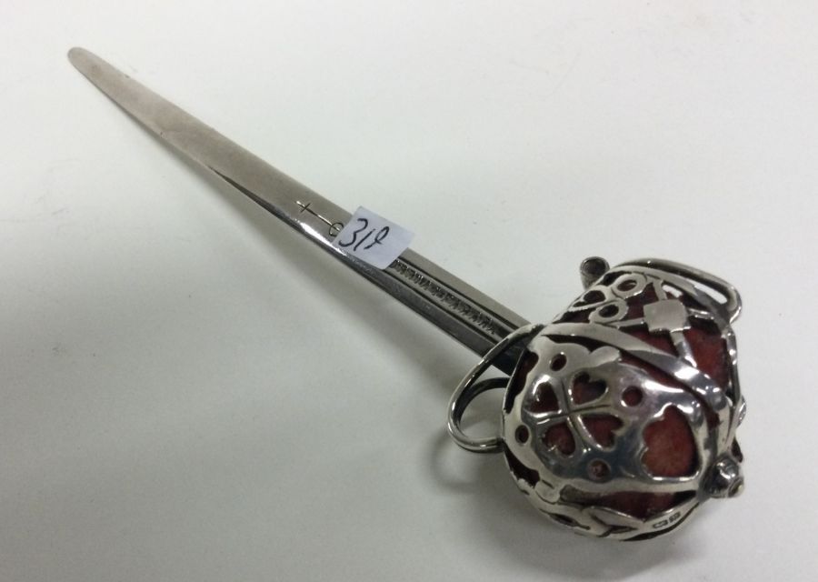 A silver paper knife in the form of a sword. Birmi