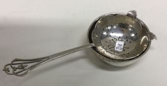 A silver tea strainer on stand. London 1964. Appro