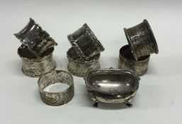 Two heavy pairs of silver napkin rings together wi