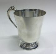 A silver christening mug with cast handle in the f