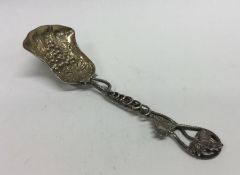 A cast Victorian silver caddy spoon in the form of