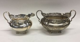 A heavy Edwardian silver cream jug together with m