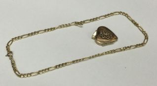 A small gold locket on fine link chain. Approx. 5