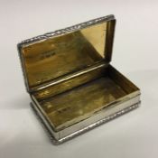 A cast silver snuff box with chased decoration. Bi