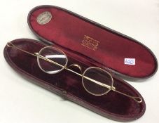 A pair of gold plated spectacles in matching case.