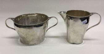 A heavy textured silver sugar bowl together with m