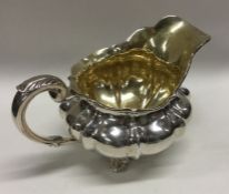 A heavy George III silver jug with gilt interior.