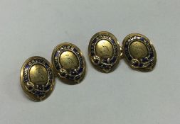 A good pair of 18 carat gold and enamelled cufflin