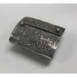A heavy chased Indian silver box with hinged lid.
