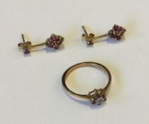 A small ruby and diamond cluster ring together wit