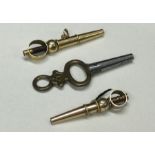 Two gold watch keys together with one plated examp