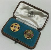 A boxed pair of fine quality ruby and pearl cuffli